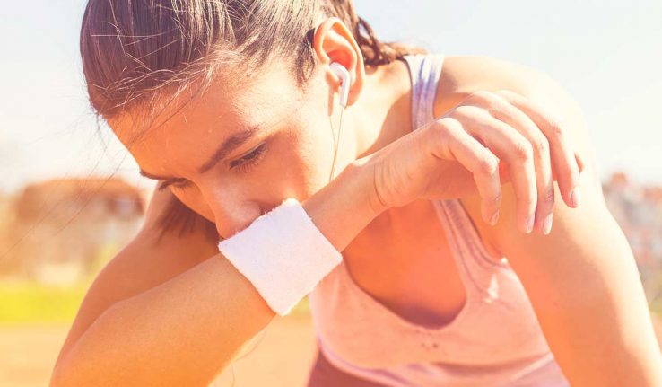 A woman struggling to run in the hot weather