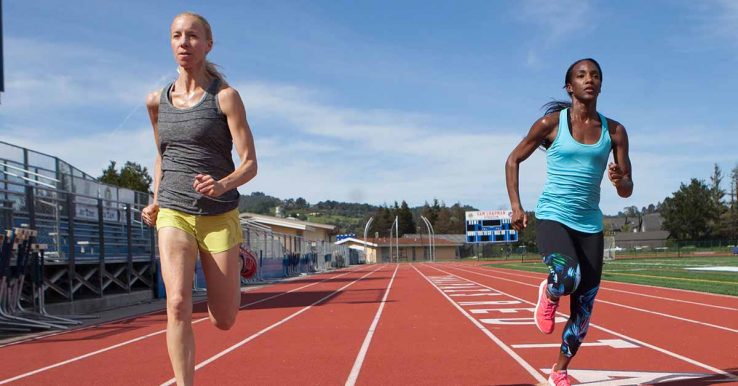 Two women racing on a running track