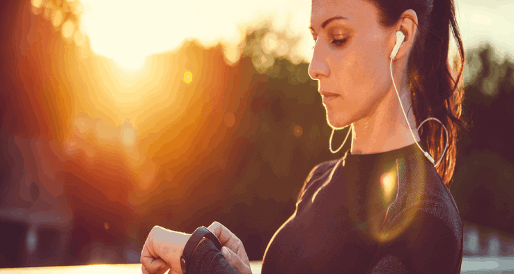 A woman getting ready to go jogging as the sun rises