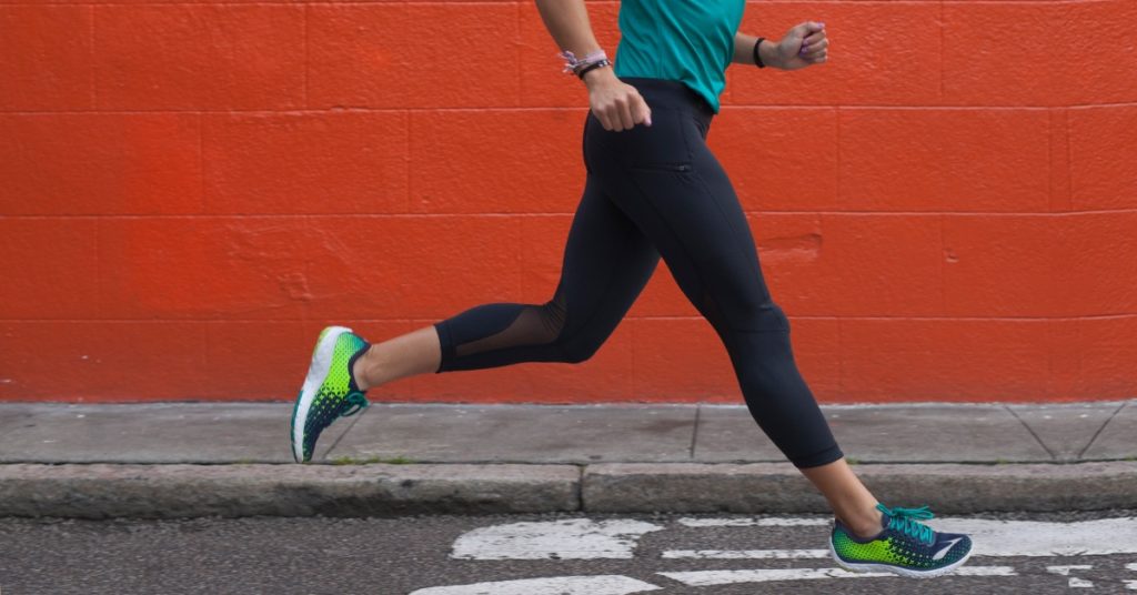 A female runner running down the road