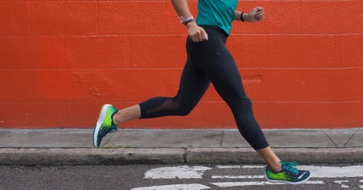 A female runner running down the road