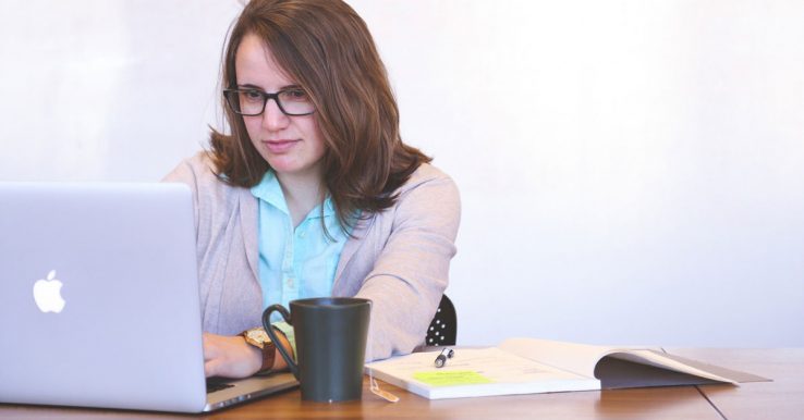 A woman sat down at her laptop working