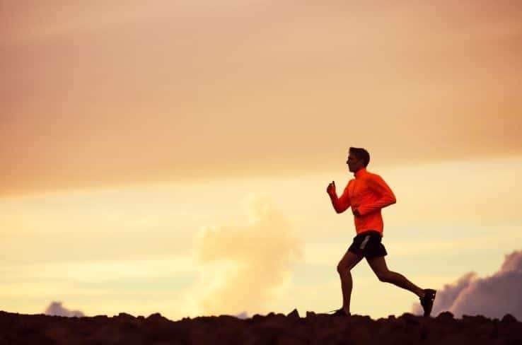 A male runner running over the mountains