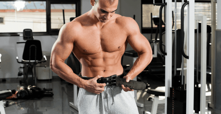 A man in the gym wearing a weight lifting belt