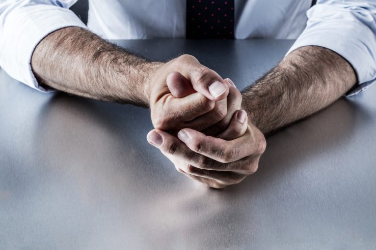 A man rubbing his hands that appears to be nervous