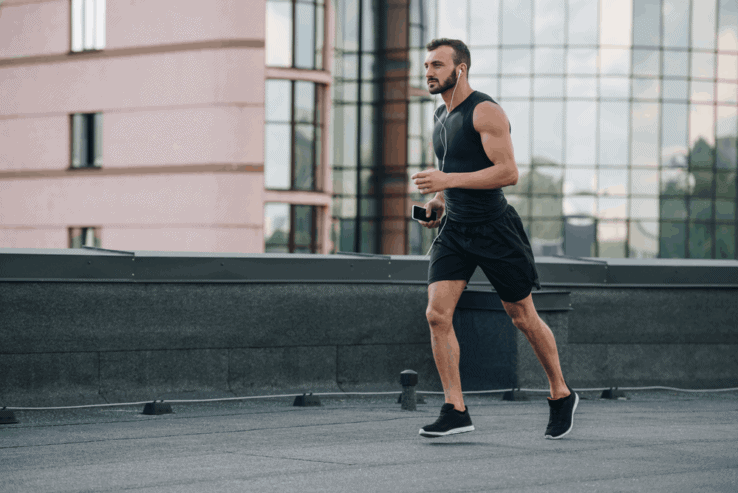 A man running on the street while listening to music