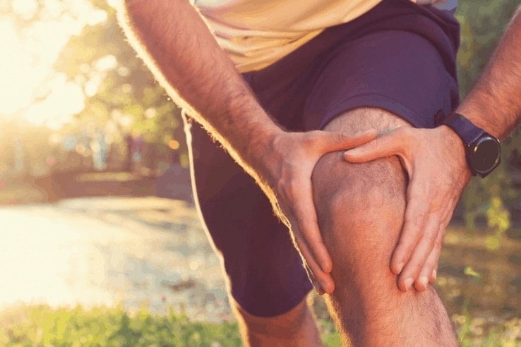 A man stretching out his sore knee