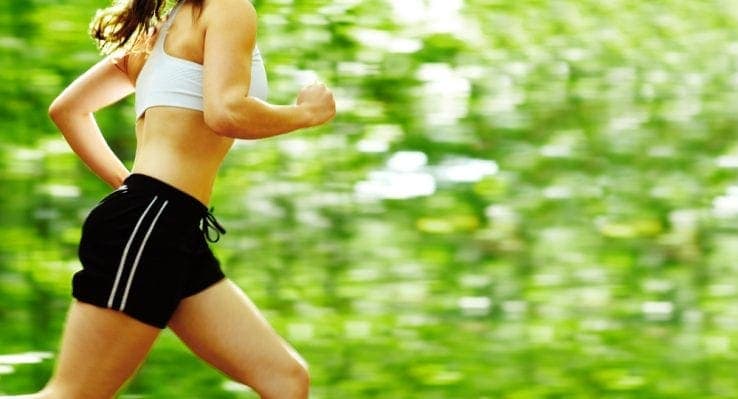 A woman running through the forest