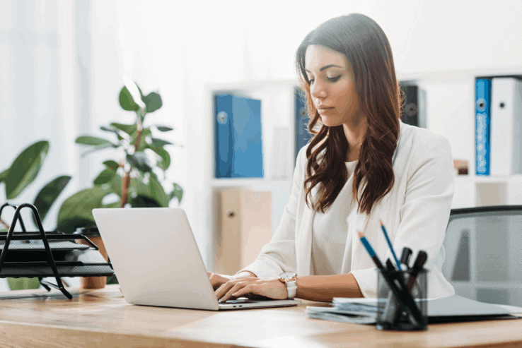 A woman sat at her office desk with good posture
