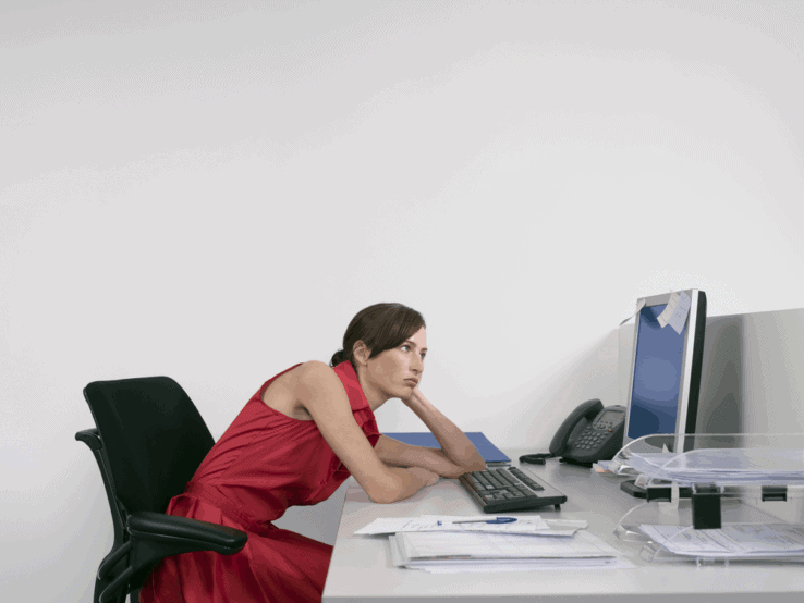 A woman slouching forward in her office chair