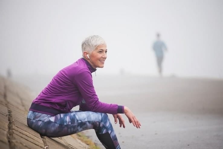 A woman smiling after finishing her daily run