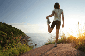 A woman stretching her quads after a long run