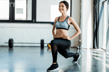 A woman stretching out her hips in the gym