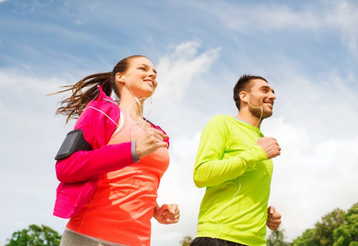 A young couple running together