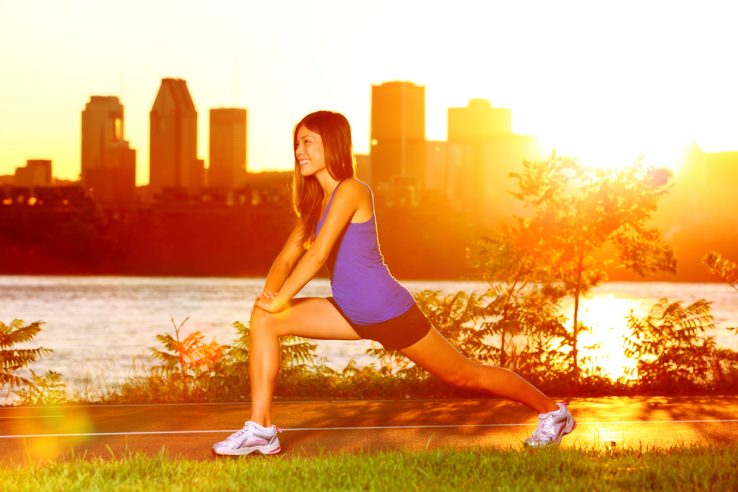 A young women warming up before running