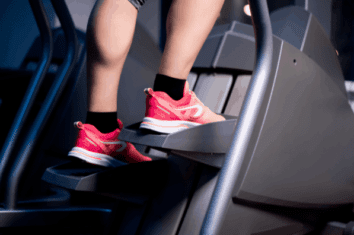Close up of a womans feet using a stair stepper