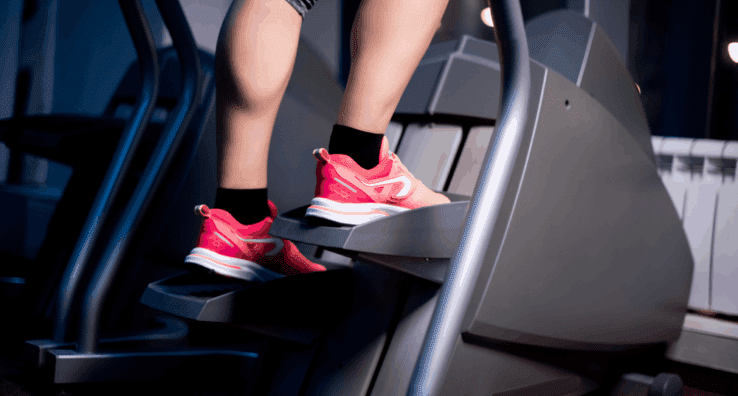 Close up of a womans feet using a stair stepper