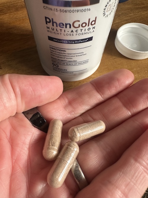 PhenGold capsules in hand