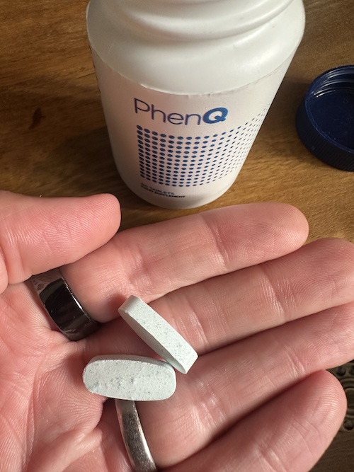 PhenQ bottle and tablets in hand