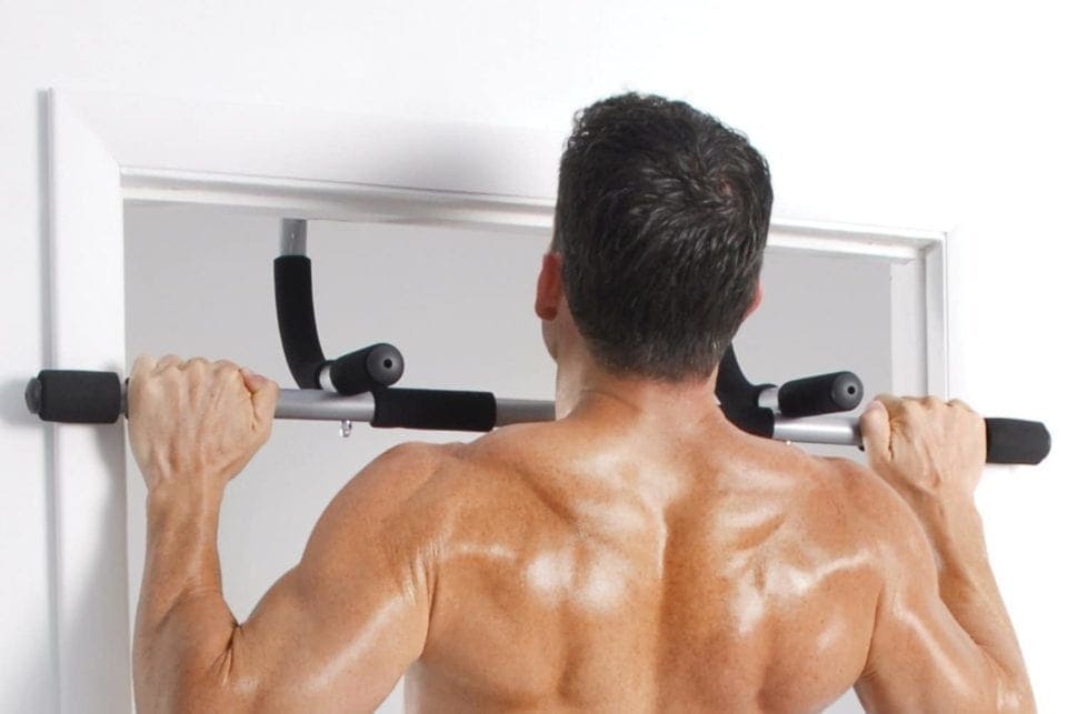 A man doing pull-ups on a doorway pull-up bar