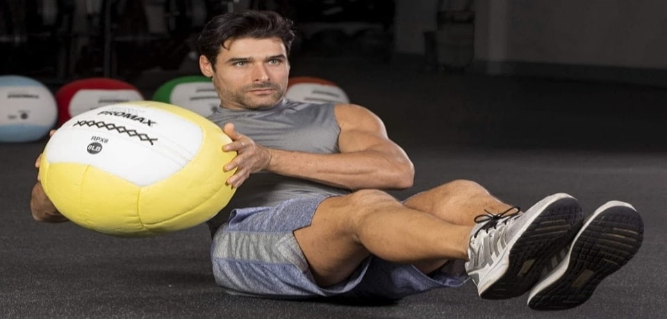 a man exercising with a medicine ball