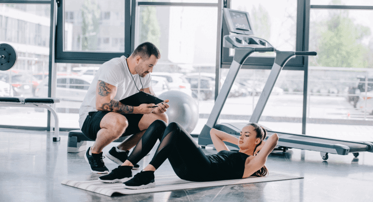 a-personal-trainer-measuring-the-time-of-a-woman