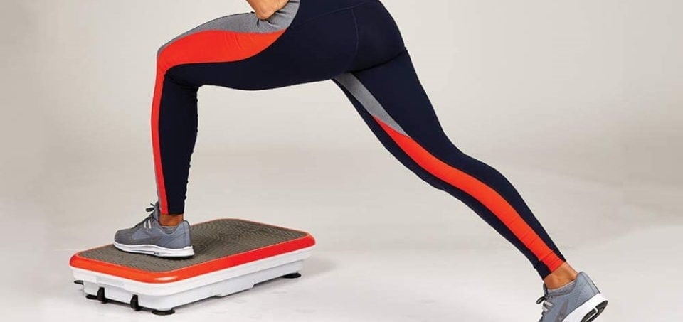 a woman exercising on a vibrating platform machine