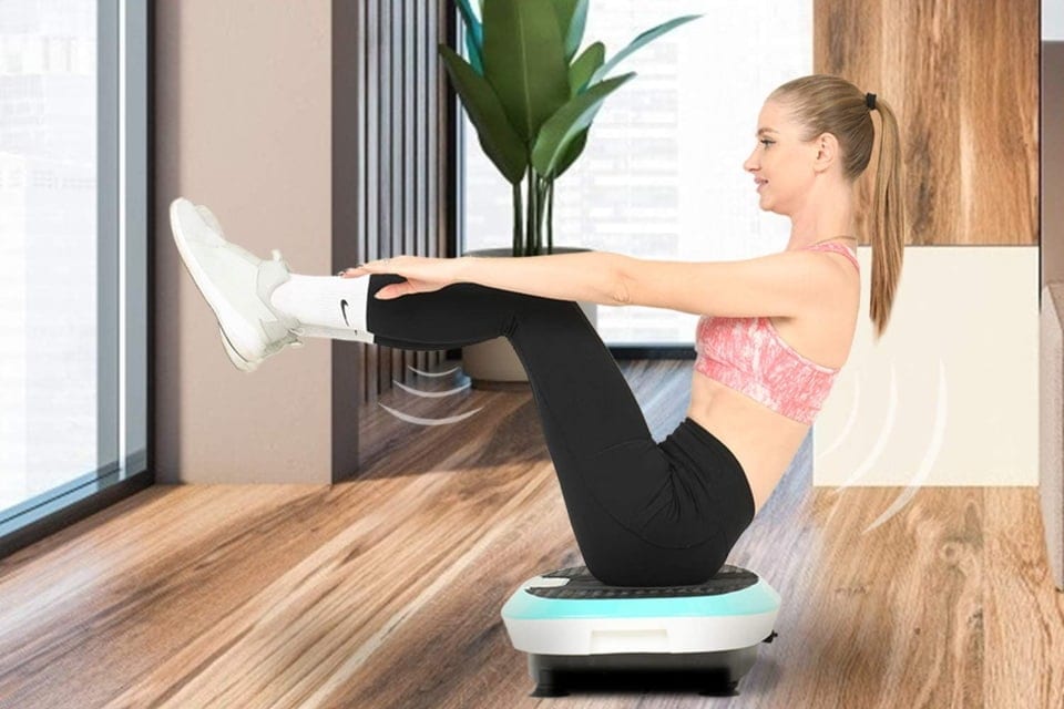 a woman sitting on a Vibration Platform Machine