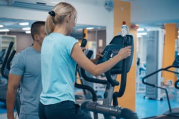 a woman using an elliptical machine at the gym