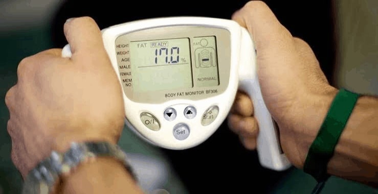 man using a body fat analyzer