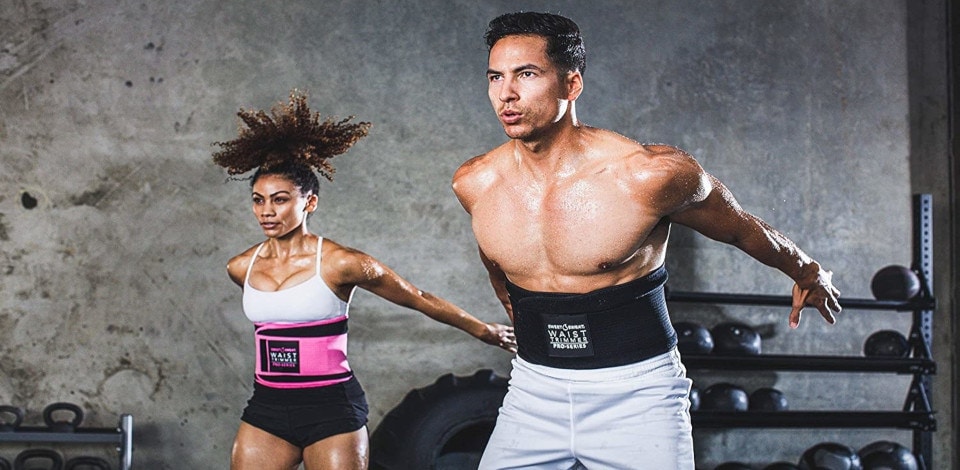 two people wearing waist trimmer belts while jumping