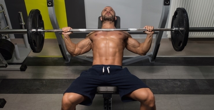 young man doing bench press exercise for chest